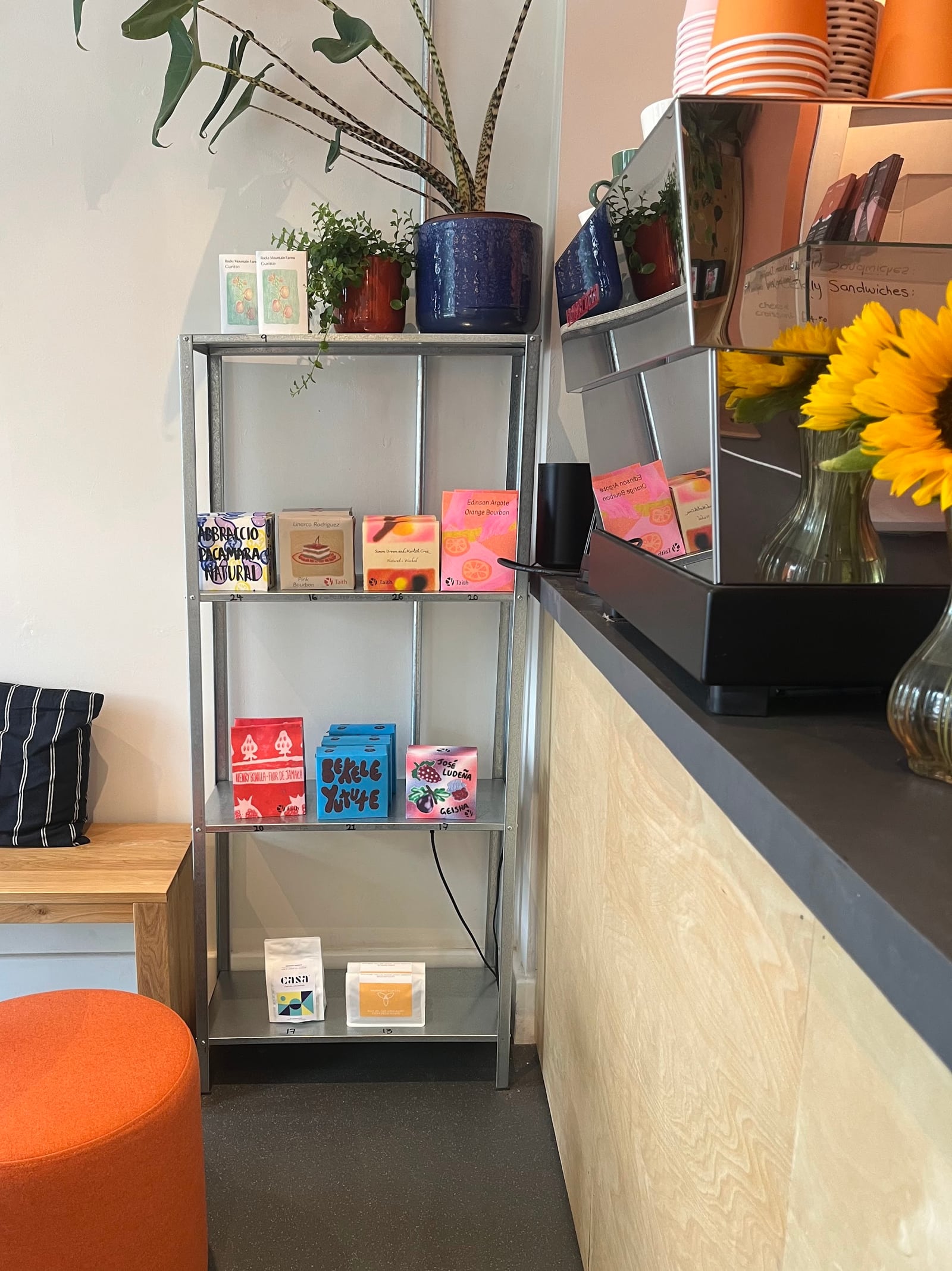 Bags of coffee to take home on the shelf beside the counter